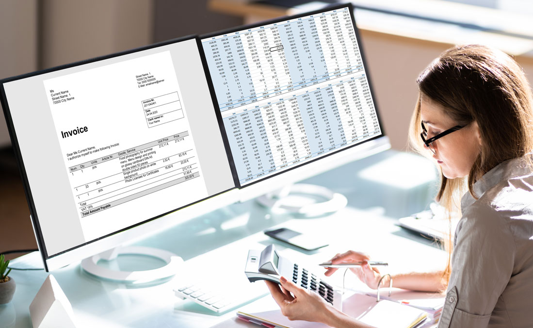 A female accountant reviewing invoices as part of bookkeeping services for small businesses